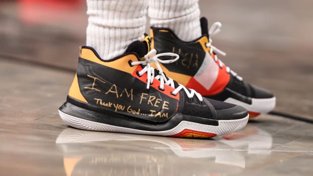 View of Kyrie Irving's black and yellow shoes.